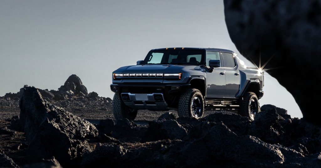 The Hummer Pickup Truck EV parked off-road during the day.