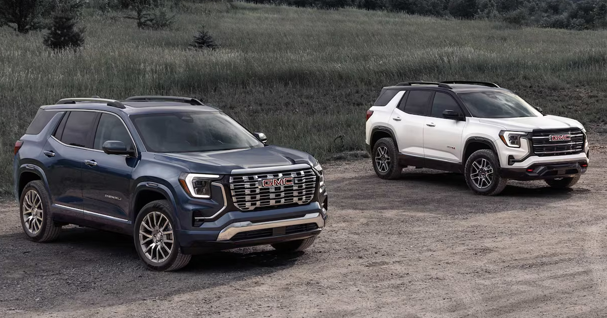 Two GMC Terrains parked beside each other on a dirt path.